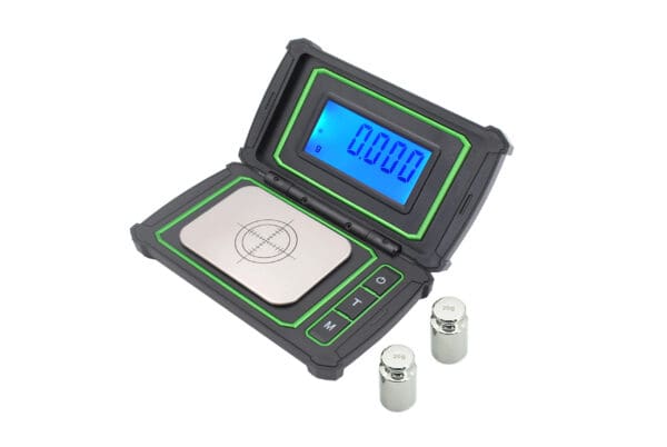 A VAR 30 Large Display Milligram Scale with a battery and two batteries.
