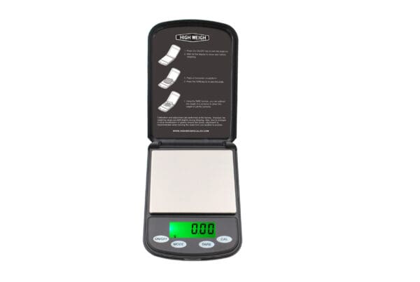 Black digital scale with green display.