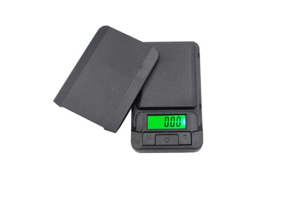 Black digital scale with green display.