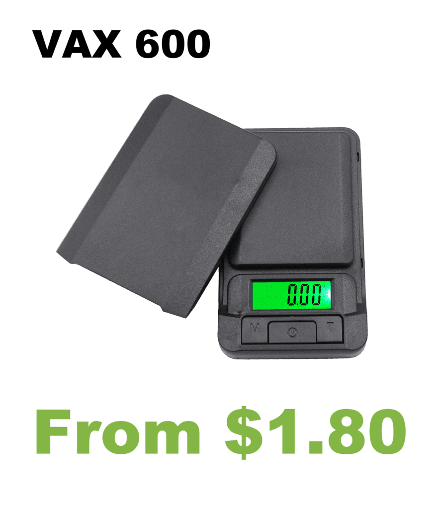 A digital scale with the words VAX 100 Compax Digital Pocket Scale.
