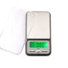 A digital scale with a green display.