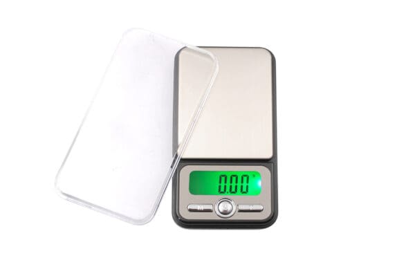 A digital scale with a green display.