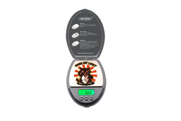 A Black Cat 100 digital pocket scale with an image of a cat on it.