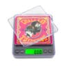 A Chillin 200 Digital Pocket Scale with a picture of a clown sitting on top of it.