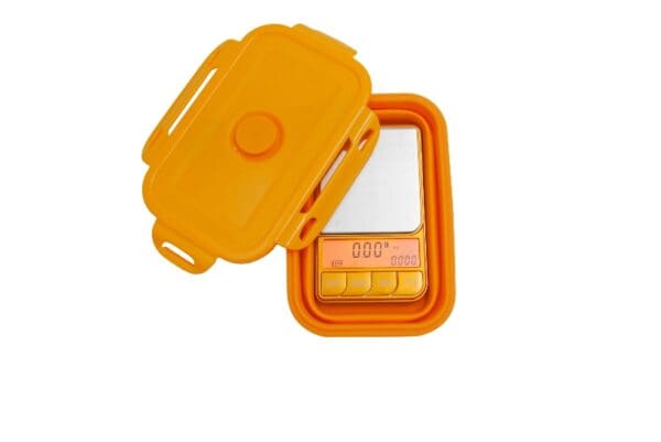 Opened orange digital pocket scale.